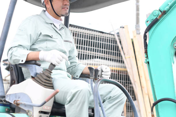 istock Middle-aged Asian male worker operating construction machinery at a construction site 1724198331