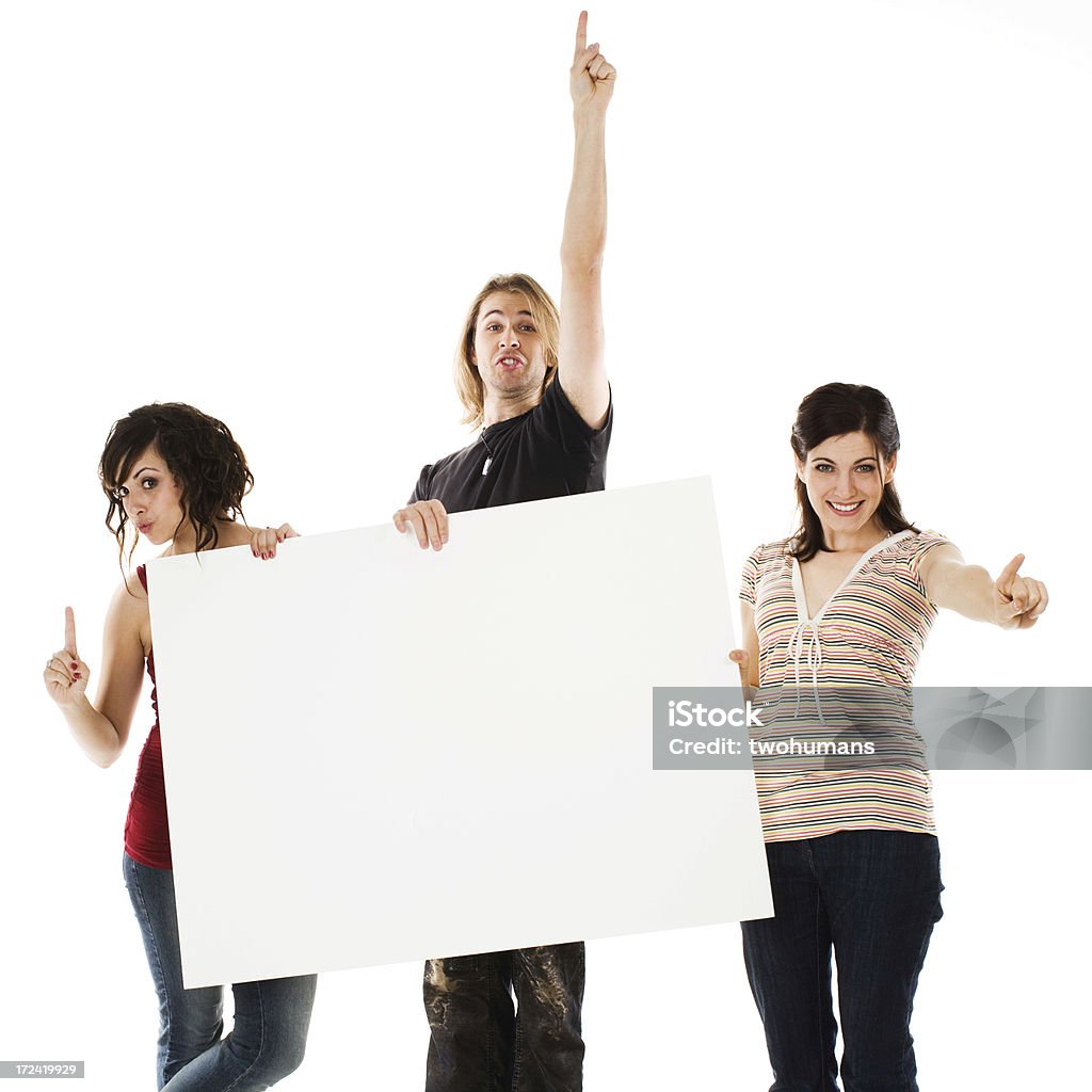 Number one "Holding a blank sign, three happy young adults are showing the number one with their fingers. Concepts: Communication; unity; number one, success. White background." Adult Stock Photo