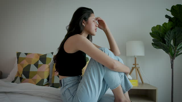 Portrait of upset Asian women feel strain or tired from mental health illness