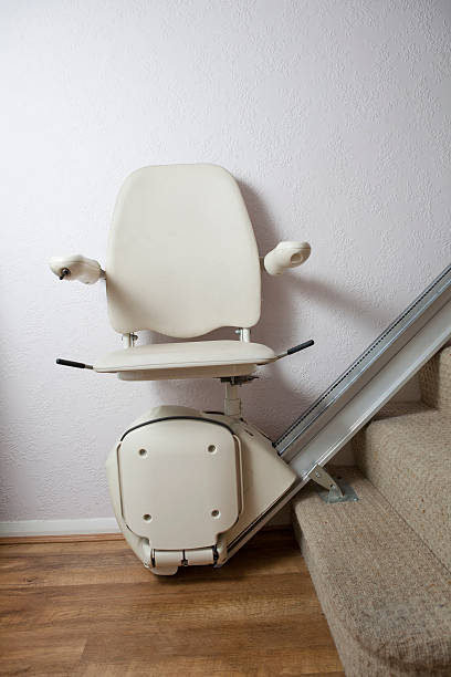 Stair lift at the bottom of the stairs stock photo