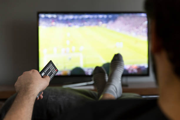 istock Man relaxing in couch watching soccer game 172421208