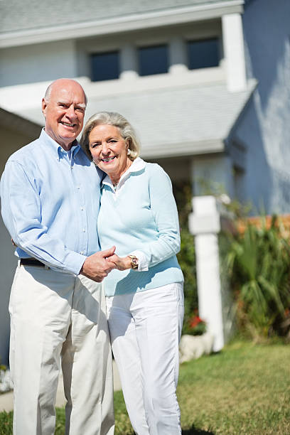 istock Happy Senior Couple Standing In Lawn 172421634