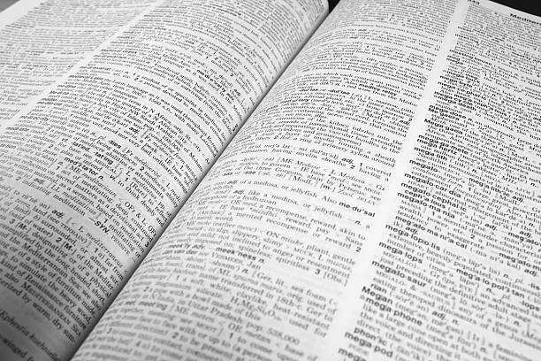 Dictionary Opened A dictionary opened to a random page.  Shallow Depth of field.  Desaturated color. dictionary stock pictures, royalty-free photos & images