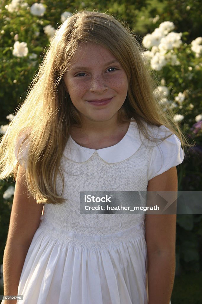 Pretty Girl A girl in front of white rosesClick below to view similar artwork: 10-11 Years Stock Photo