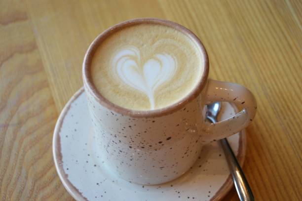 istock Beige cup with cappuccino coffee and saucer on a wooden table surface. Breakfast, lunch. 1724221419