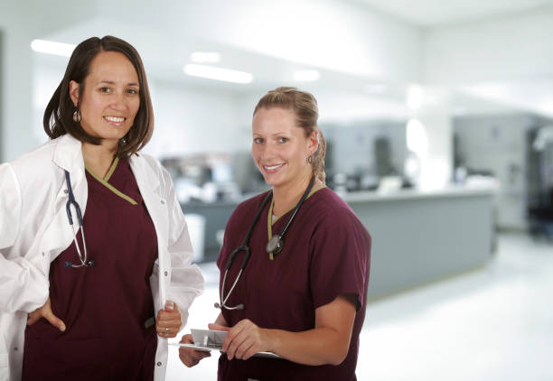 Medical "Doctors, nurses, or other staff in a surgical center." red medical scrubs stock pictures, royalty-free photos & images