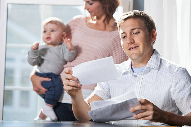 istock Mother and baby, father paying bills 172422921