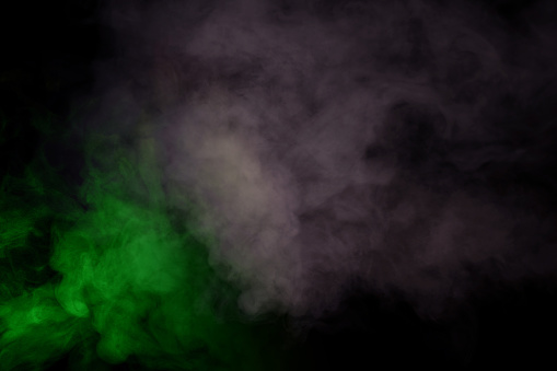 Red and green steam on a black background. Copy space.