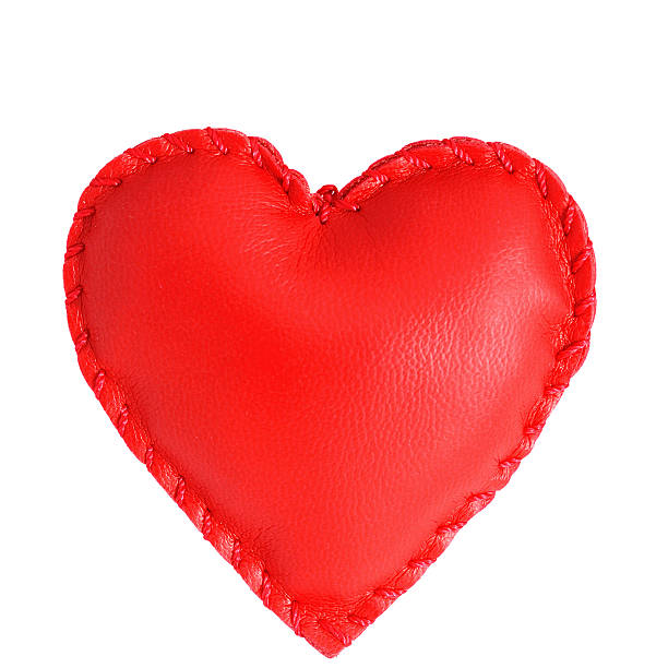 Red heart shaped leather pillow on white background stock photo