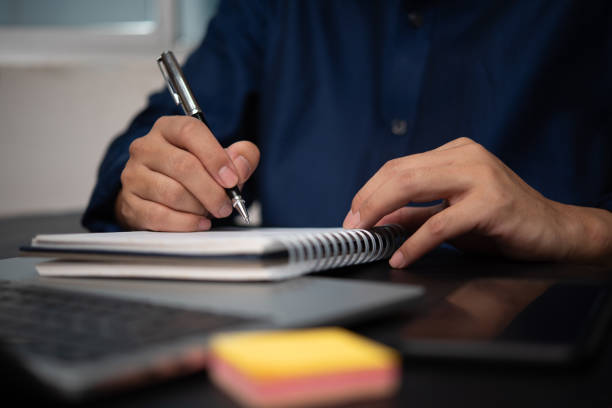 istock man hands with pen writing on notebook in the office.learning, education and work.writes goals, plans, make to do and wish list on desk. 1724238023