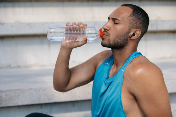 istock Man in sportswear having a break in workout and drinking water 1724239127
