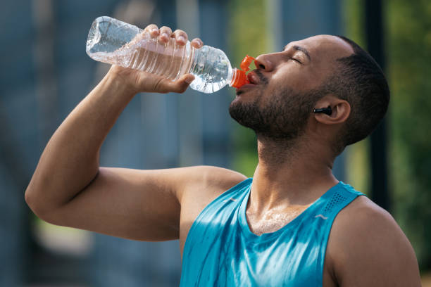 istock Sportsman feeling thirsty after workout and drinking water 1724239449