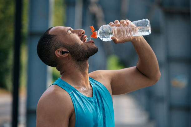 istock Sportsman feeling thirsty after workout and drinking water 1724239604