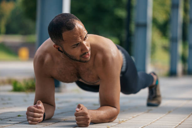 istock Young well-built african american man standing in plank 1724239774