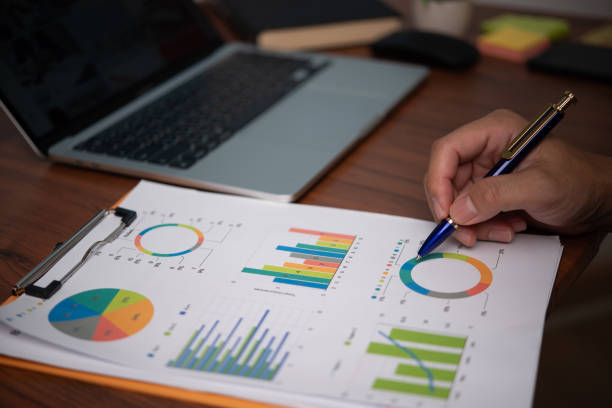 istock Businessman pointing chart analysis document and paperwork financial plan marketing with laptop on desk office. 1724239782