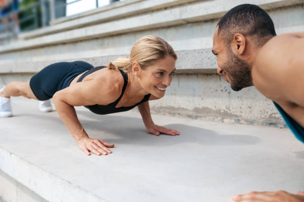 istock Athletic man and woman training doing push-ups outdoor. 1724241048