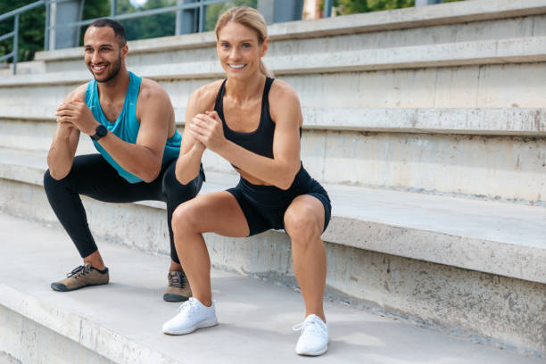istock Man and woman squatting on open air together. 1724241059