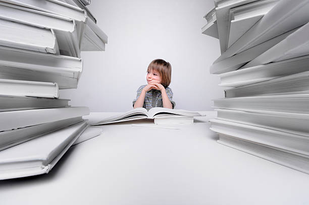 istock Young boy bored and frustrated with his homework 172424325