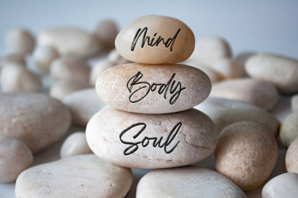 istock Mind, Body and soul text engraved on white zen stones 1724250730