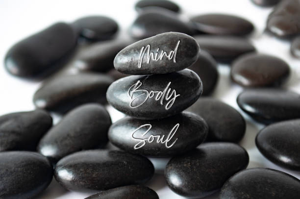istock Mind, Body and soul text engraved on black zen stones 1724250735