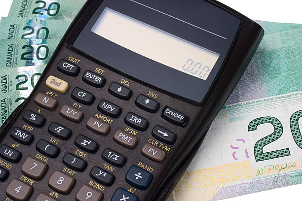 A calculator and paper money notes stock photo