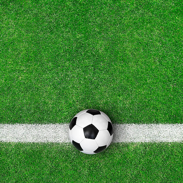 Soccer ball on green grass. Top view.