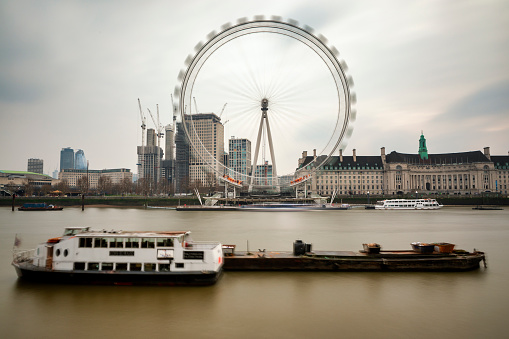 August 19, 2019 – River Thames, London, United Kingdom. The London Eye one of the most famous landmarks in London sits alongside the River Thames.
