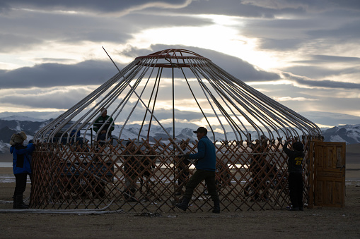 Bayan-Olgii Province, Mongolia - October 1, 2023: People disassembling a ger (yurt) at the end of the Ulgii Golden Eagle Festival.