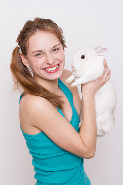 istock Beautiful girl with her pet rabbit 172426345