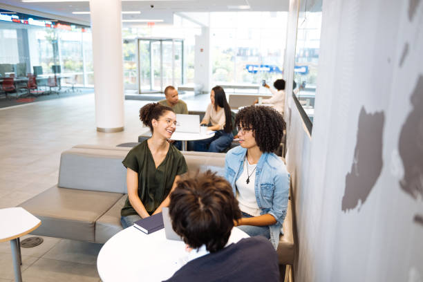 istock Group of diverse university students in campus, talking in lobby after classes. Adult students exchange information and know-how among each other 1724263981