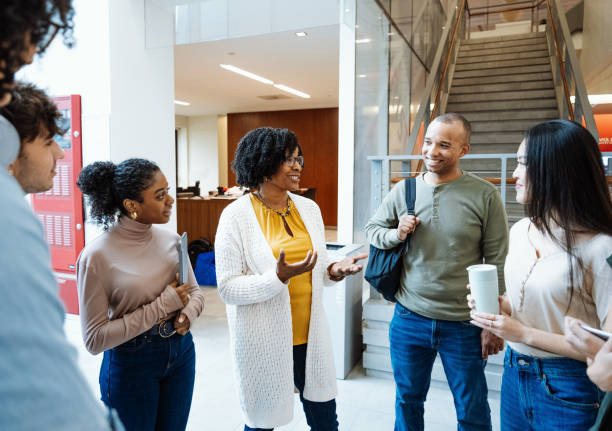 istock Diverse university students in campus. Students talking to female African professor during the seminar 1724264535