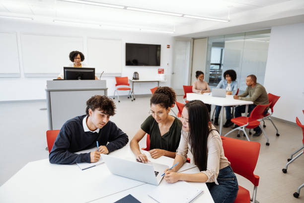 istock University students in classroom working on laptop, supervised by African lecturer, in modern classroom 1724265132