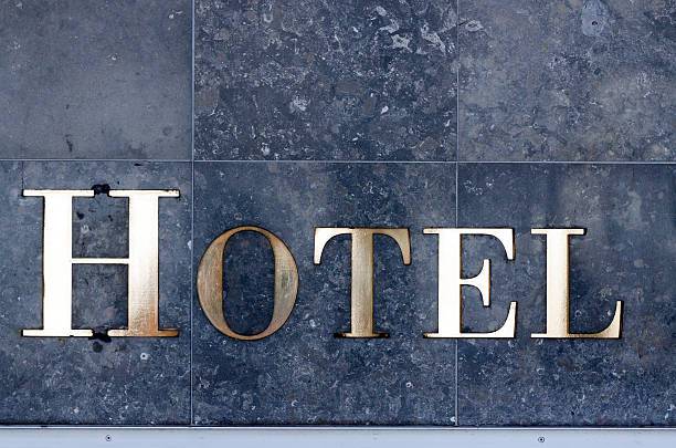 istock Golden sign HOTEL on tiled wall, copy space 172426927