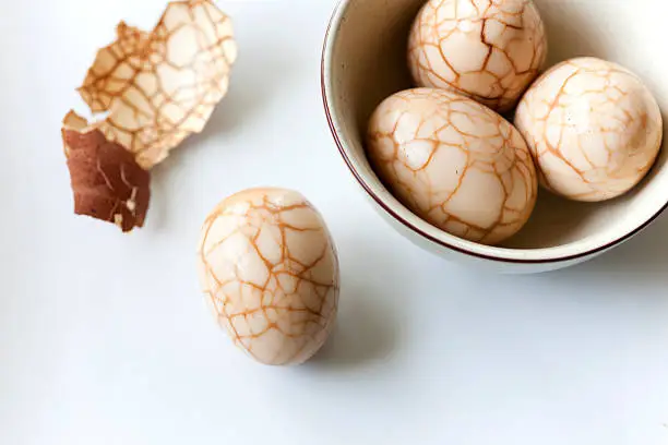 "Also known as marble eggs, these eggs are hardboiled eggs that have had their shells cracked then steeped in a black tea/soy sauce and spice infusion. The cracks in the shell allow the beautiful colors and textures to appear and let the umami flavors infuse into the egg."