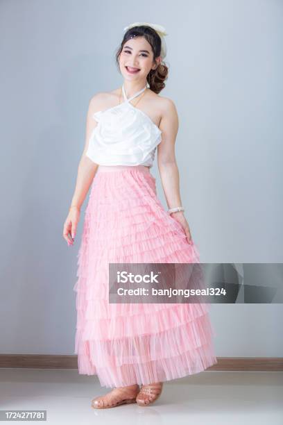 Beautiful Lady in Luxury Lush Pink Dress. Fashion Brunette Smiling Woman in  Gorgeous Long Gown Posing Isolated on White Studio Ba Stock Photo - Image  of fashionable, healthy: 102686710