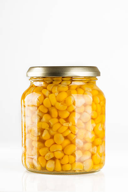 Sweet corn in glass jar isolated on white stock photo