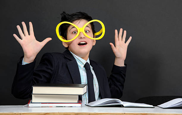 school boy screaming nerd boy screaming with his hands raised. blackboard child shock screaming stock pictures, royalty-free photos & images