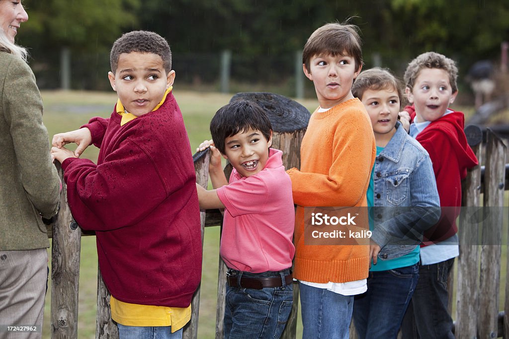 School children on field trip Teacher with multi-ethnic group of elementary school children on a field trip, visiting the zoo. 10-11 Years Stock Photo