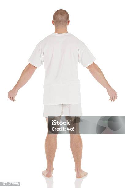 Foto de Vista Traseira De Um Homem Em Pé Em Cuecas e mais fotos de stock de Camiseta - Camiseta, De Braço Levantado, Fundo Branco