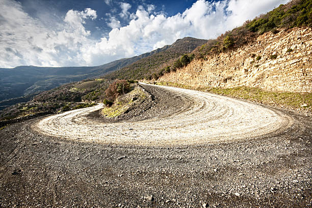 Sand and stone winding road Sand and stone empty winding road. rally car racing stock pictures, royalty-free photos & images