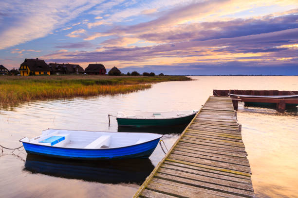 Lake Neusiedl in the Burgenland region , Austria. Scenic bay with wooden pier and cottage.