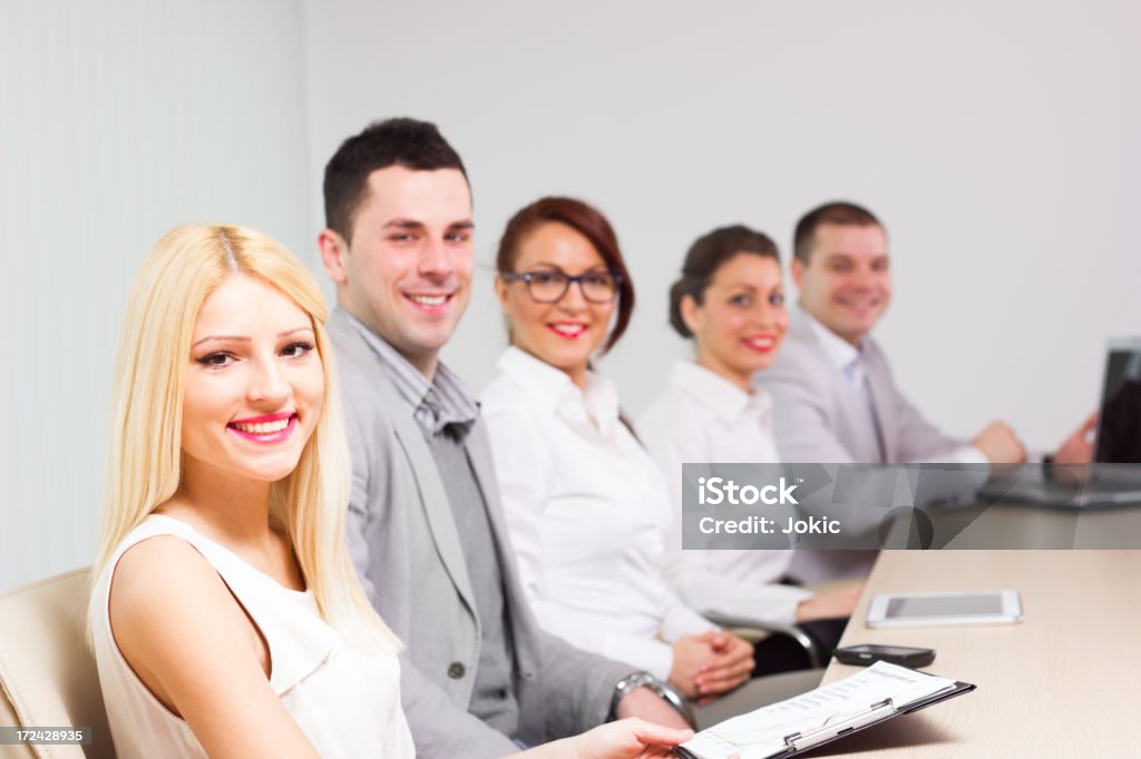 Group of businesspeople having a meeting. Business People Sitting in a Line. Group Of People Stock Photo