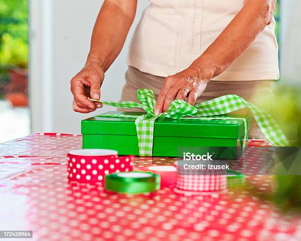 Senior Woman Wrapping Gift Stock Photo - Download Image Now - 60-64 Years, Adult, Adults Only