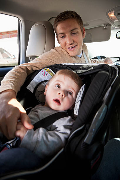 istock Father with baby in car seat 172430183