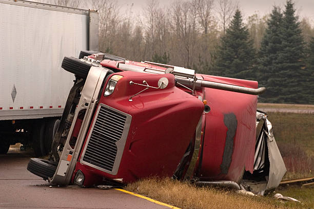 Truck crash with turned over semi Transport truck crashed with jack knifed trailer lays on side of freeway.There's more truck accident scenes in my portfolio. colliding photos stock pictures, royalty-free photos & images