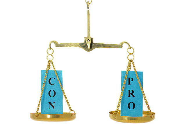 Balance between pro and con on scale stock photo