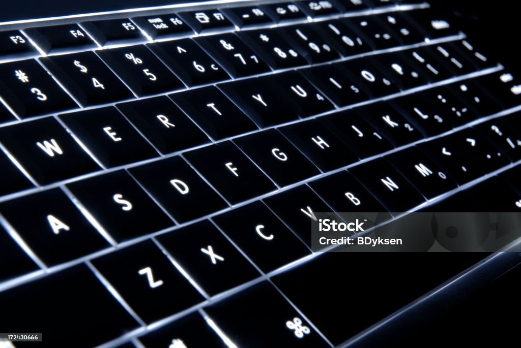 Illuminated Keyboard Laptop keyboard illuminated in the dark. Black Color Stock Photo