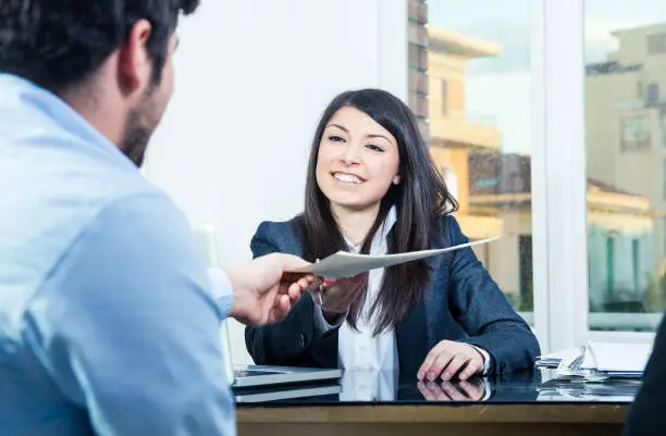 Confident businesswoman receiving contracts.