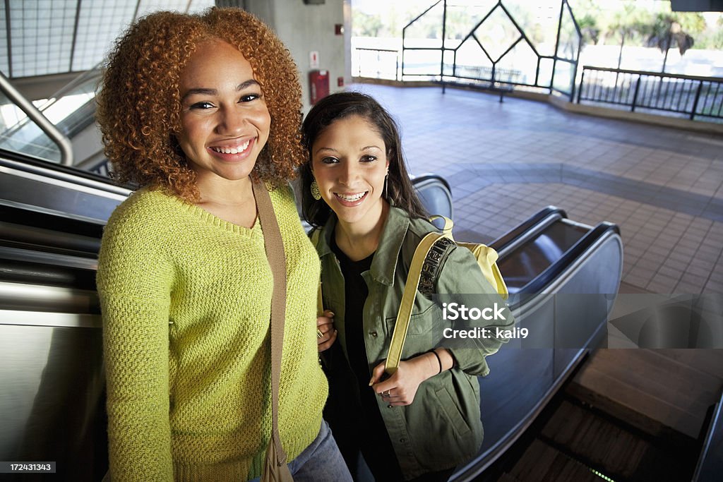 Chica adolescente en la escalera mecánica - Foto de stock de Amistad libre de derechos