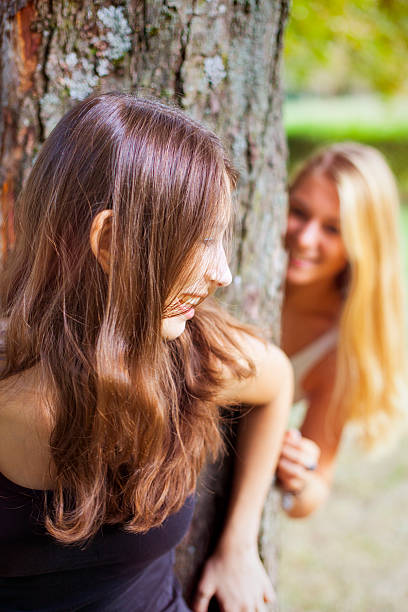 istock Friends playing hide and seek in the park 172431344